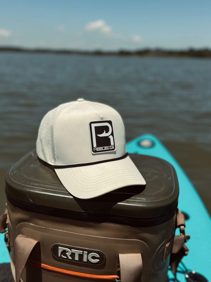 Reeled In rope hat resting on a kayak at the ramp